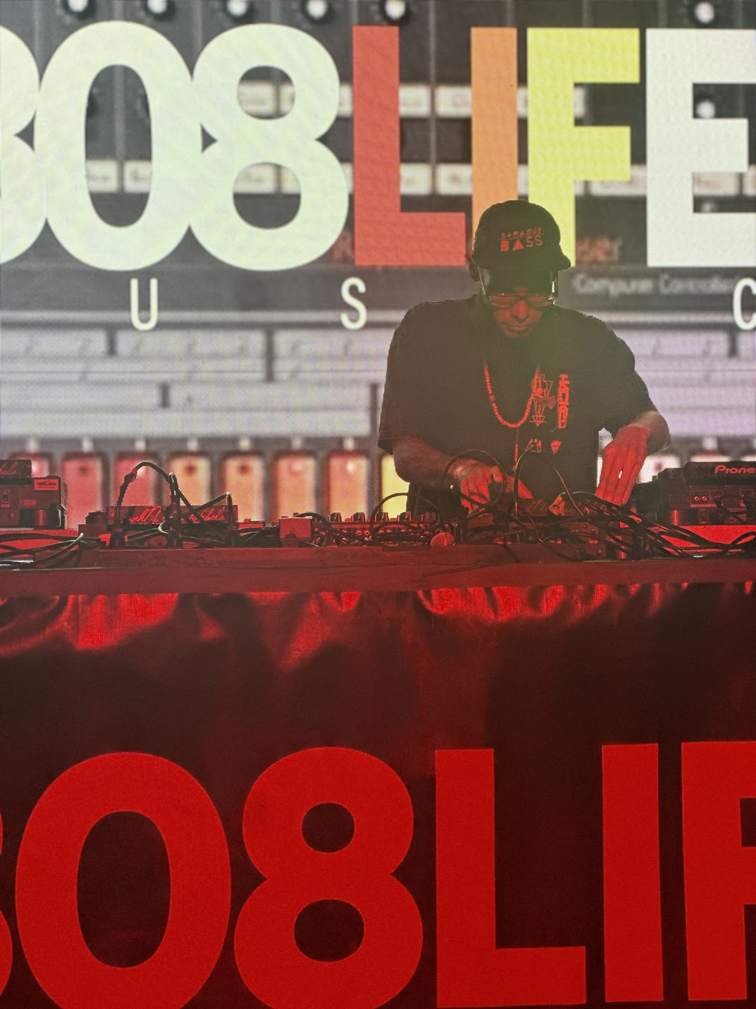 DJ performing in front of the 808 Life visual wall